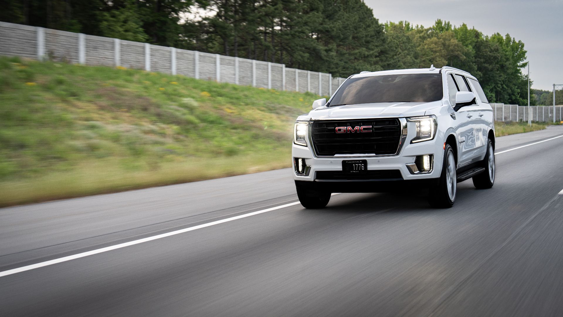 White GMC Yukon XL captured while driving on a Charlotte, NC highway.