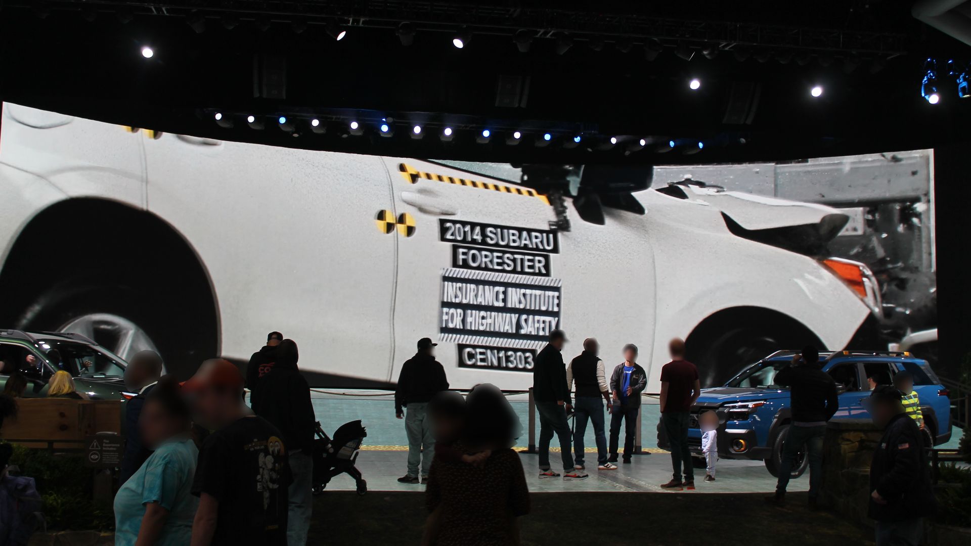 Subaru Forester IIHS Crash Test footage on a large projector at the 2025 NYC Auto Show