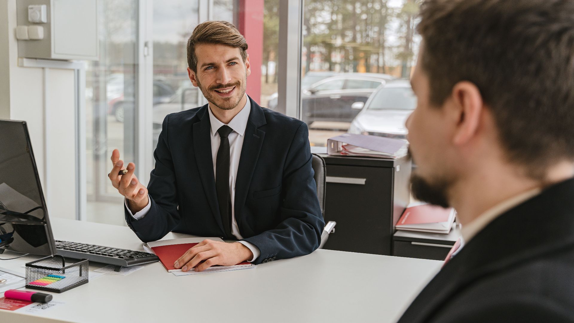Two businessmen having a conversation in a modern office setting.