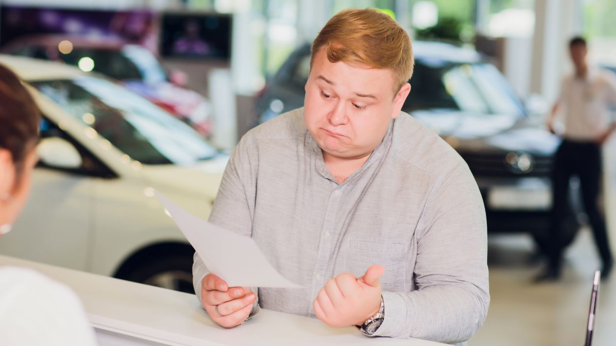 Shutterstock-1142278016, successful businessman in car dealership - sale of vehicles to customers