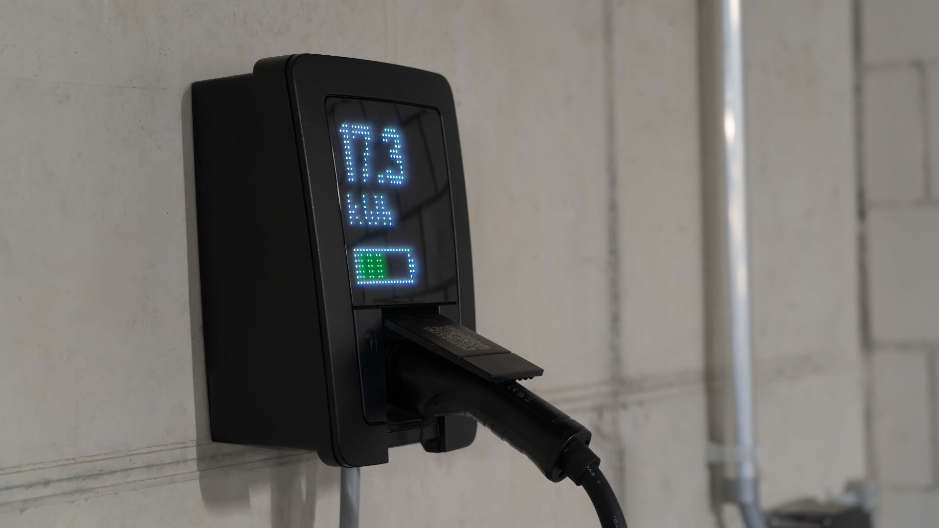 Detailed view of an electric vehicle charging station indoors, showcasing charging technology.