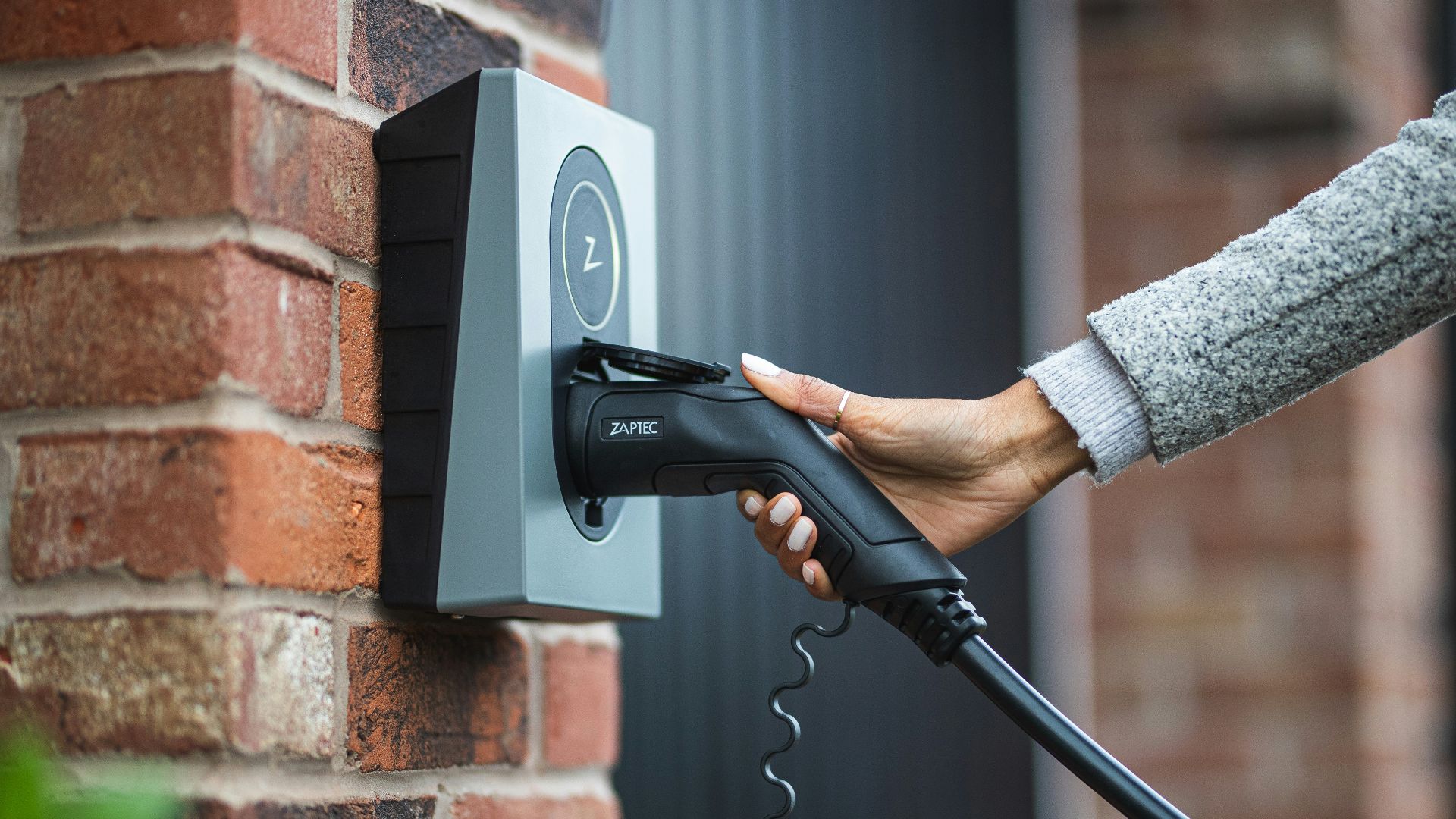 a person is charging an electric car with a charger