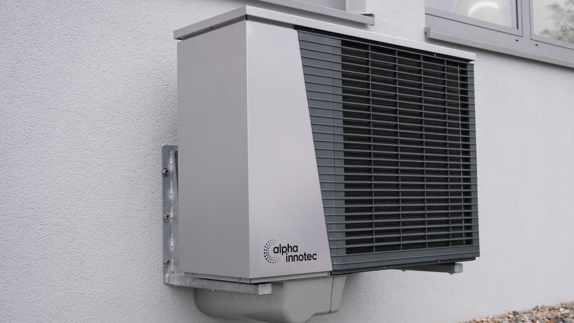 Outdoor air conditioning unit mounted on a residential building exterior.