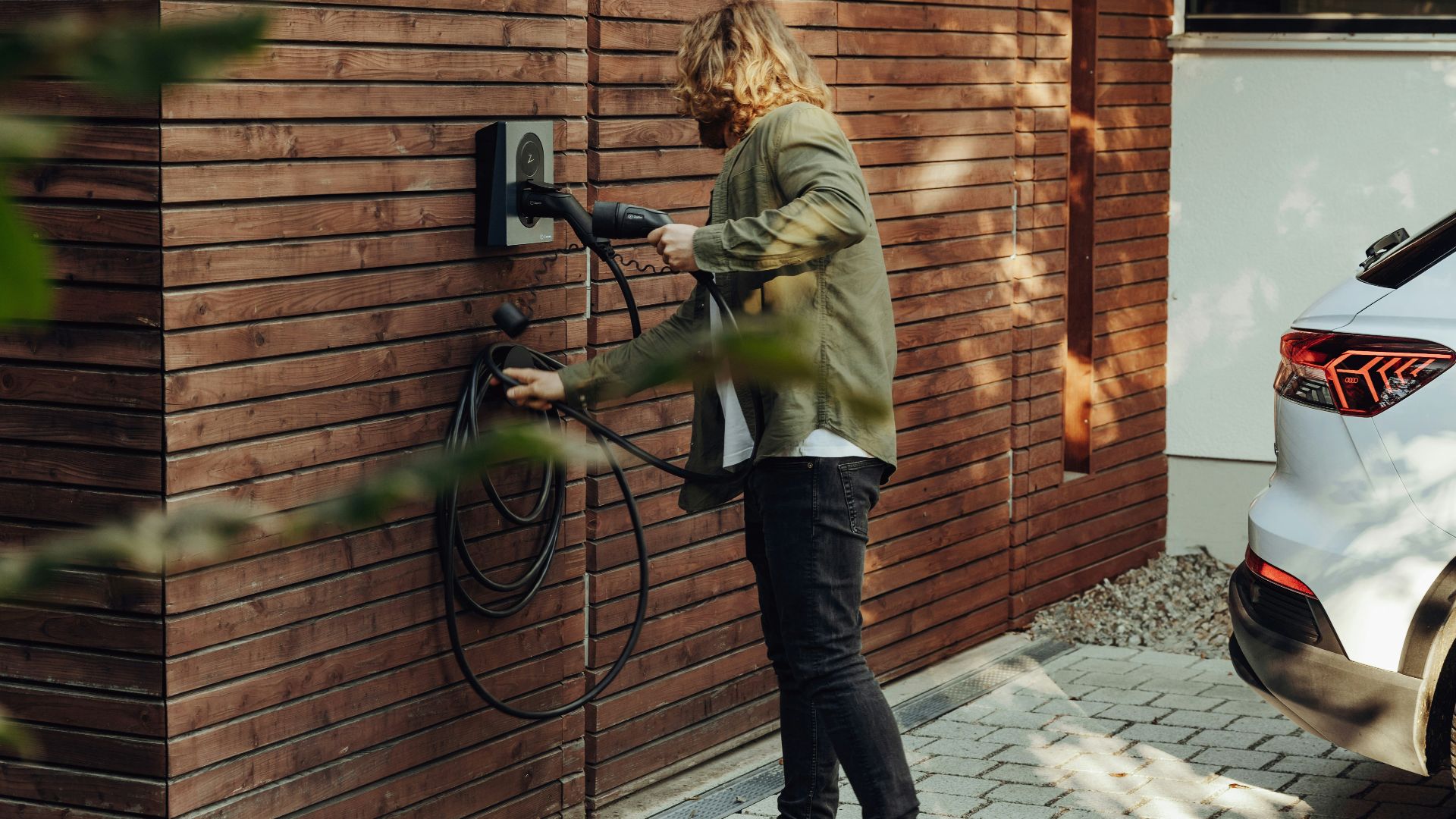 a woman is using a power washer on a brick wall