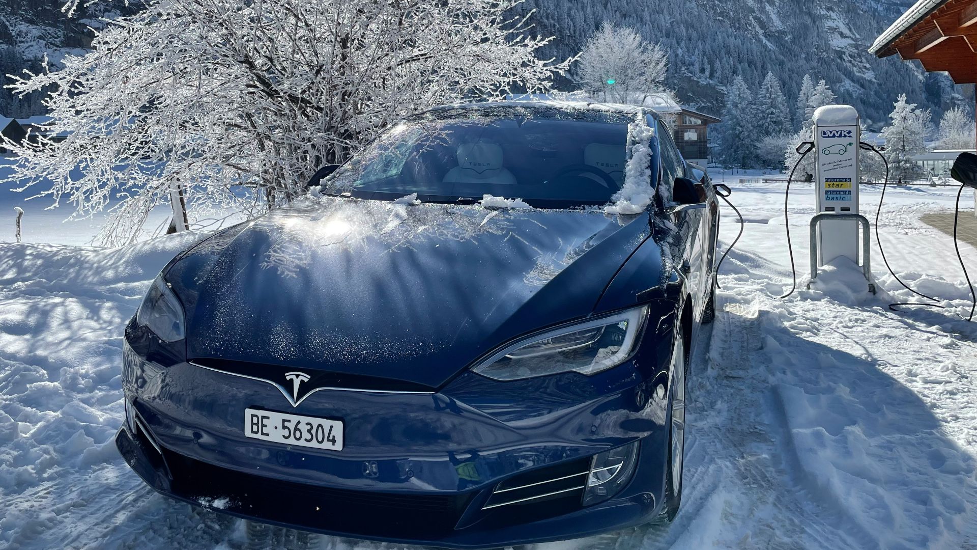 black car on snow covered ground during daytime