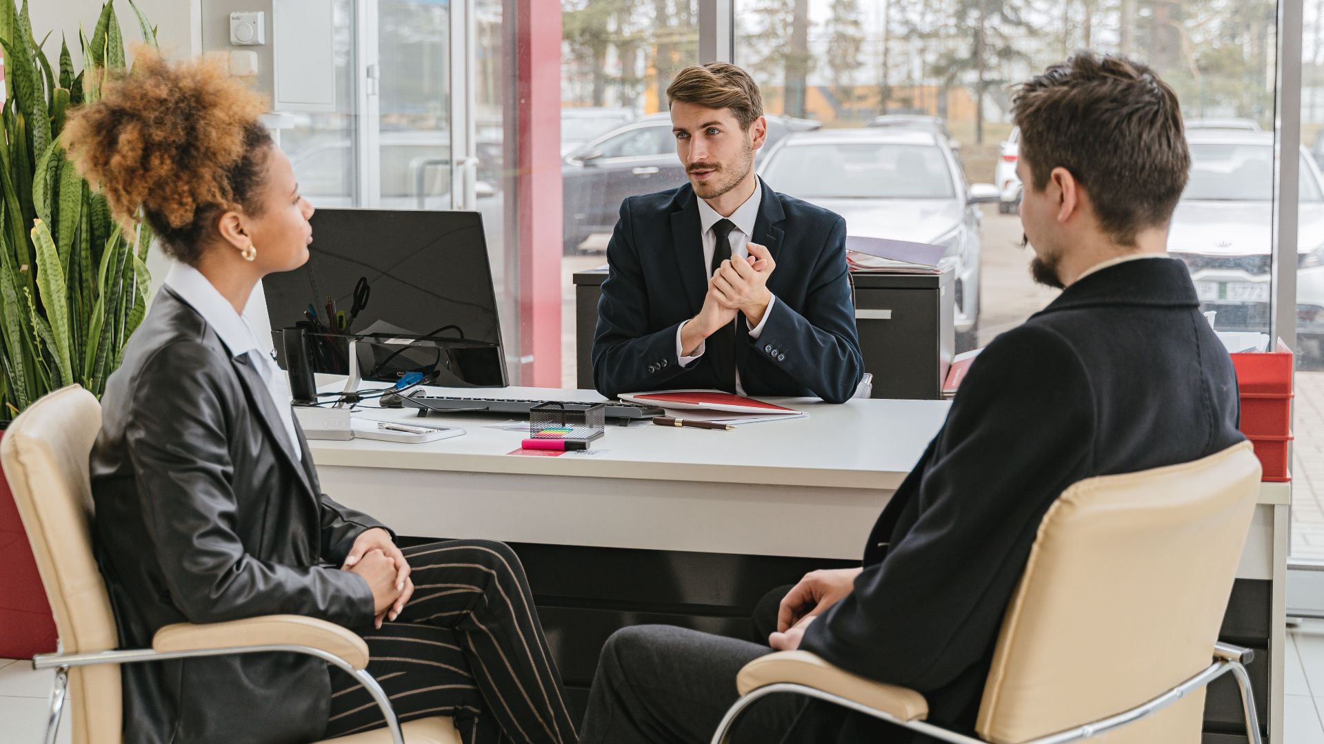 Professional meeting with clients at a modern office, discussing business solutions.