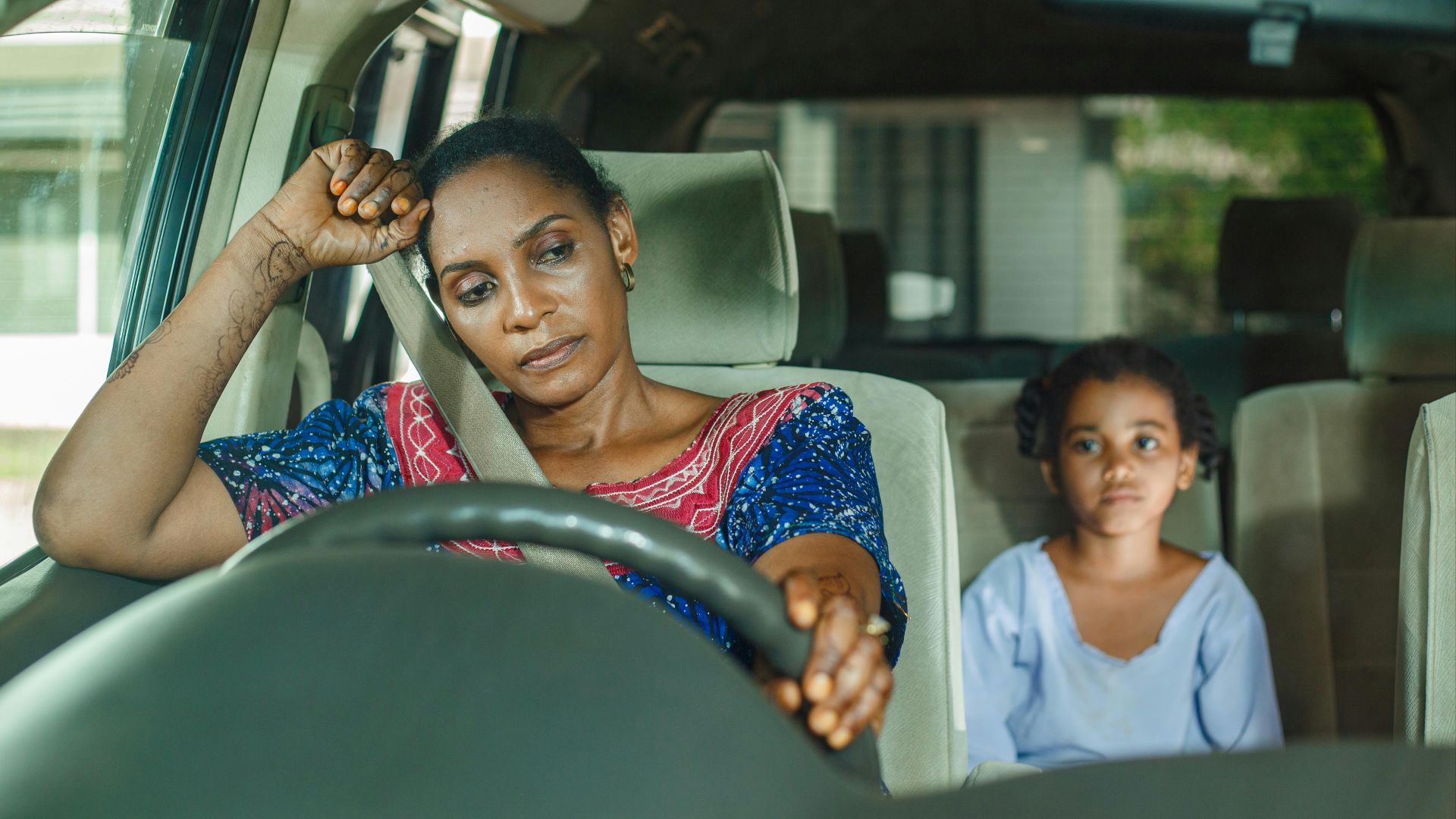 a woman and a child sitting in a car