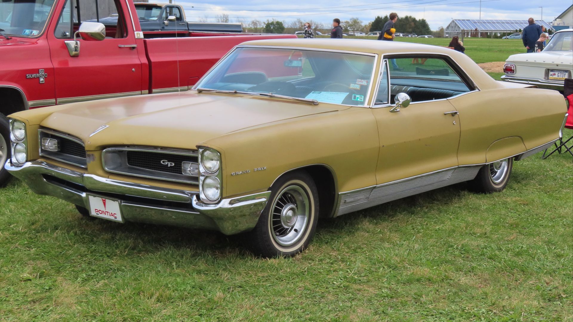 1966 Pontiac Grand Prix hardtop coupe photographed at the 16th Annual Down on the Farm Car Cruise in Mercer, Pennsylvania. Finished in Tiger Gold.