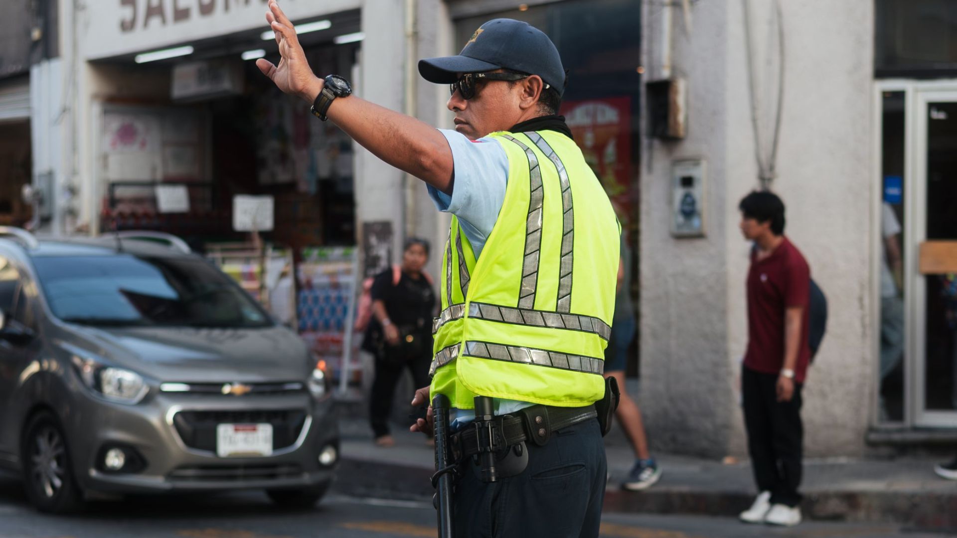 A traffic officer directs vehicles on a bustling urban street, ensuring road safety and flow.