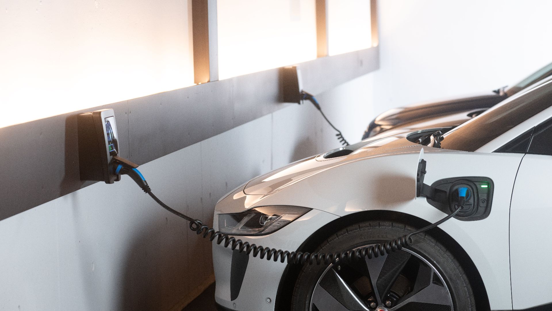 Electric car charging in a modern indoor station promoting sustainability and energy efficiency.