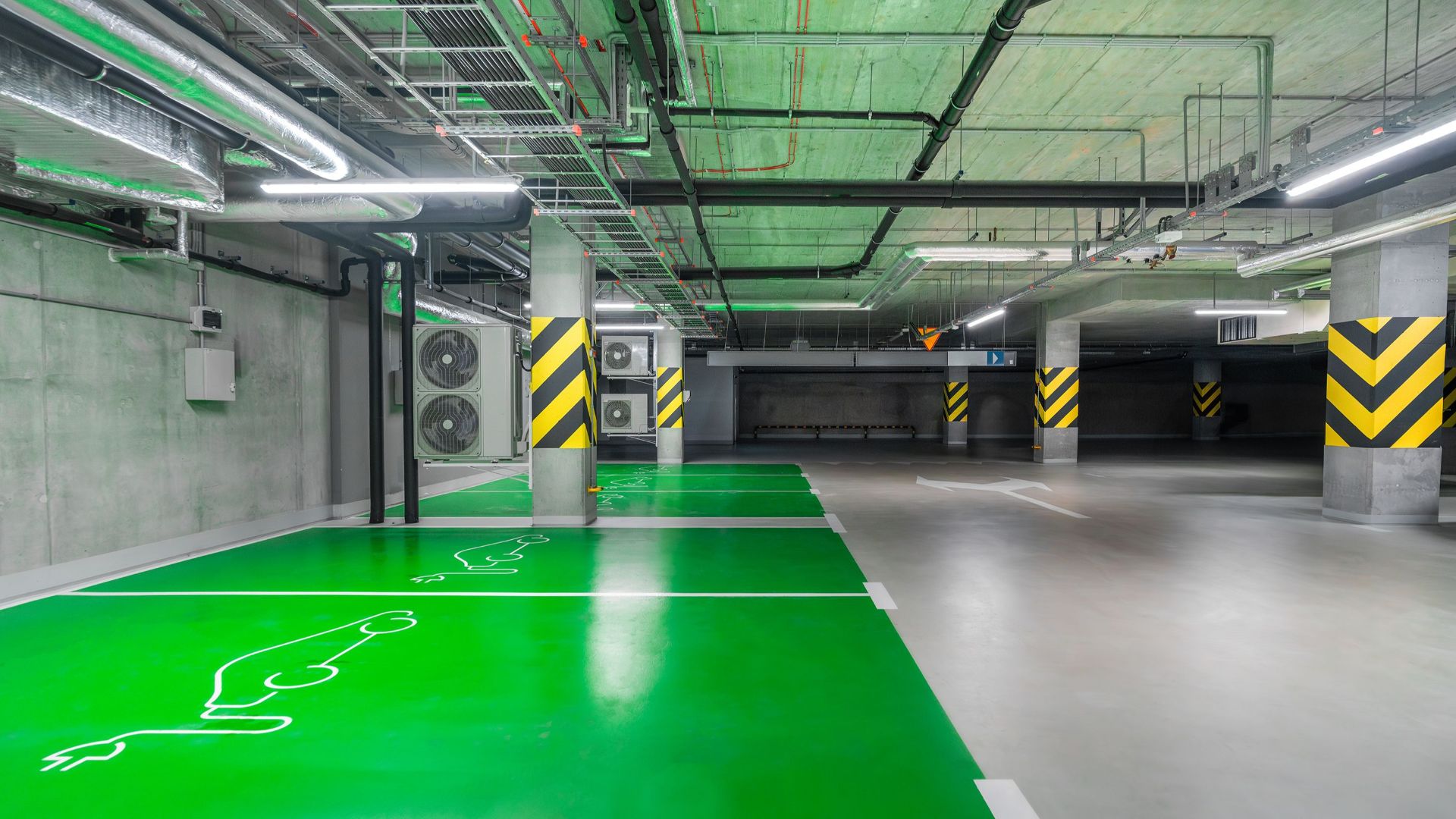 Modern green electric car charging station in an underground parking lot, eco-friendly urban solution.