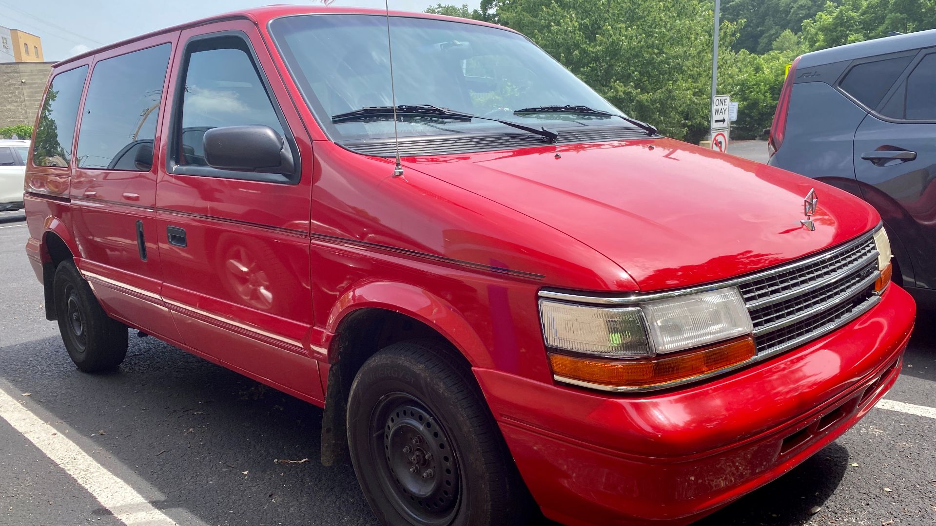 1994 Plymouth Voyager base photographed in Heidelberg, Pennsylvania. This Voyager is equipped with the 3.0L V6 engine, and assembled in Windsor, Ontario. Looks to have an aftermarket paint job and stripe, and if it had hubcaps, would look rather nice.