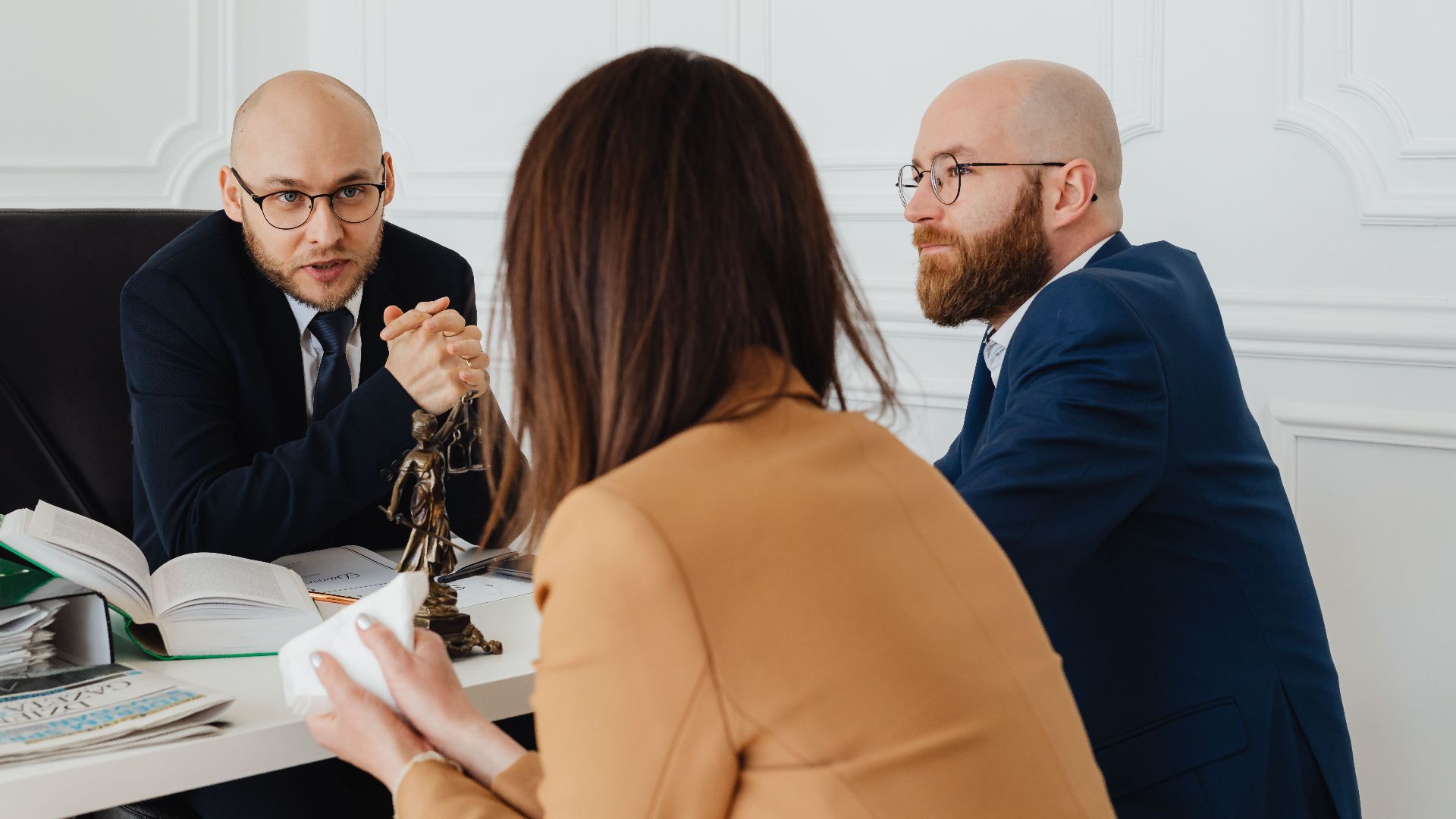 Professional discussion among lawyers in a modern office, focusing on legal matters.