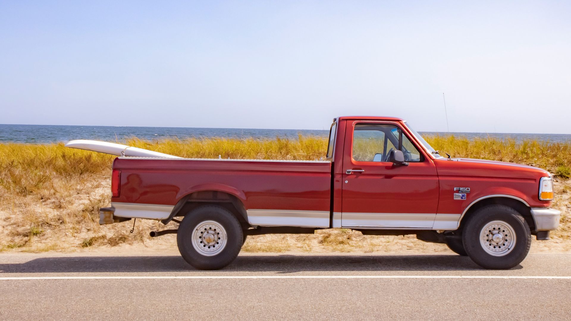 brown crew cab pickup truck on road during daytime