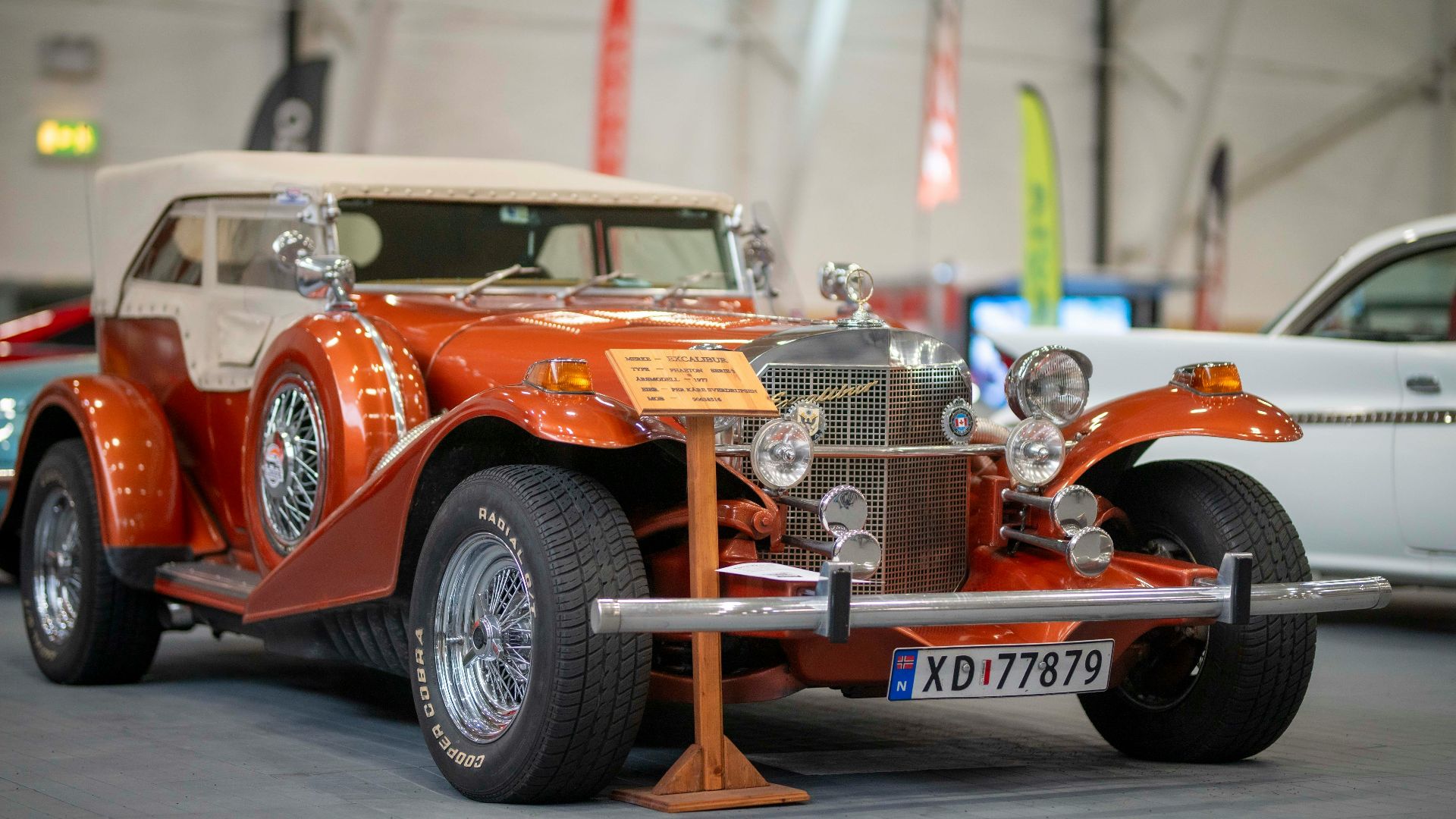 Vintage orange convertible car on display