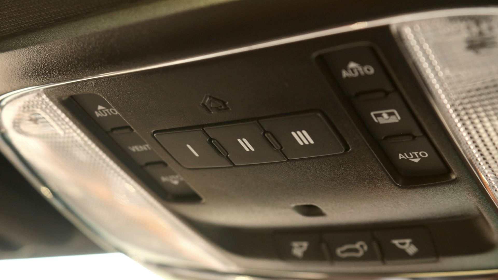Automotive overhead console featuring, among other controls, HomeLink buttons and LED status indicator.