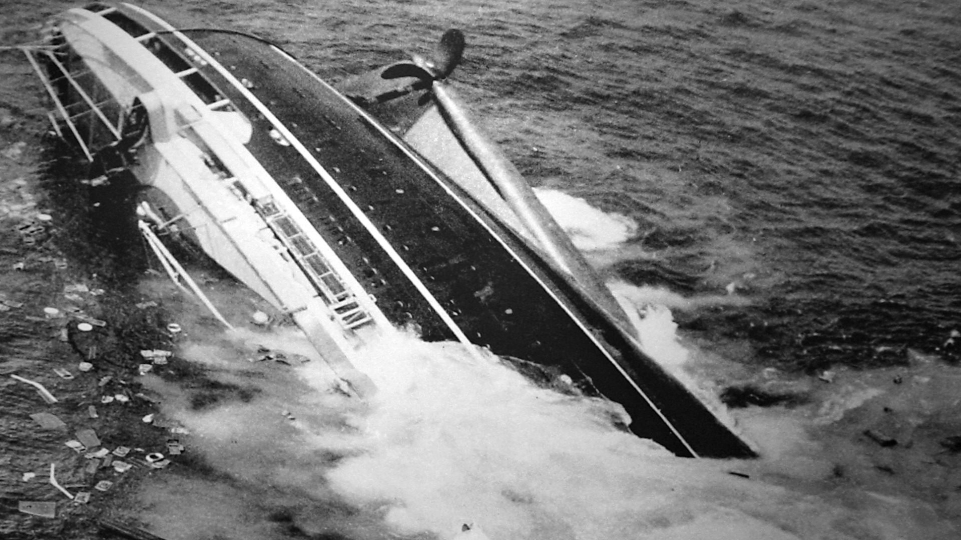 Photo of the SS Andrea Doria half submerged after colliding with the Swedish ship Stockholm off the coast of Nantucket Island, Massachusetts in July 1956. When Trask won the 1957 Pulitzer Prize for Photography for his photos of the sinking ship, this imag