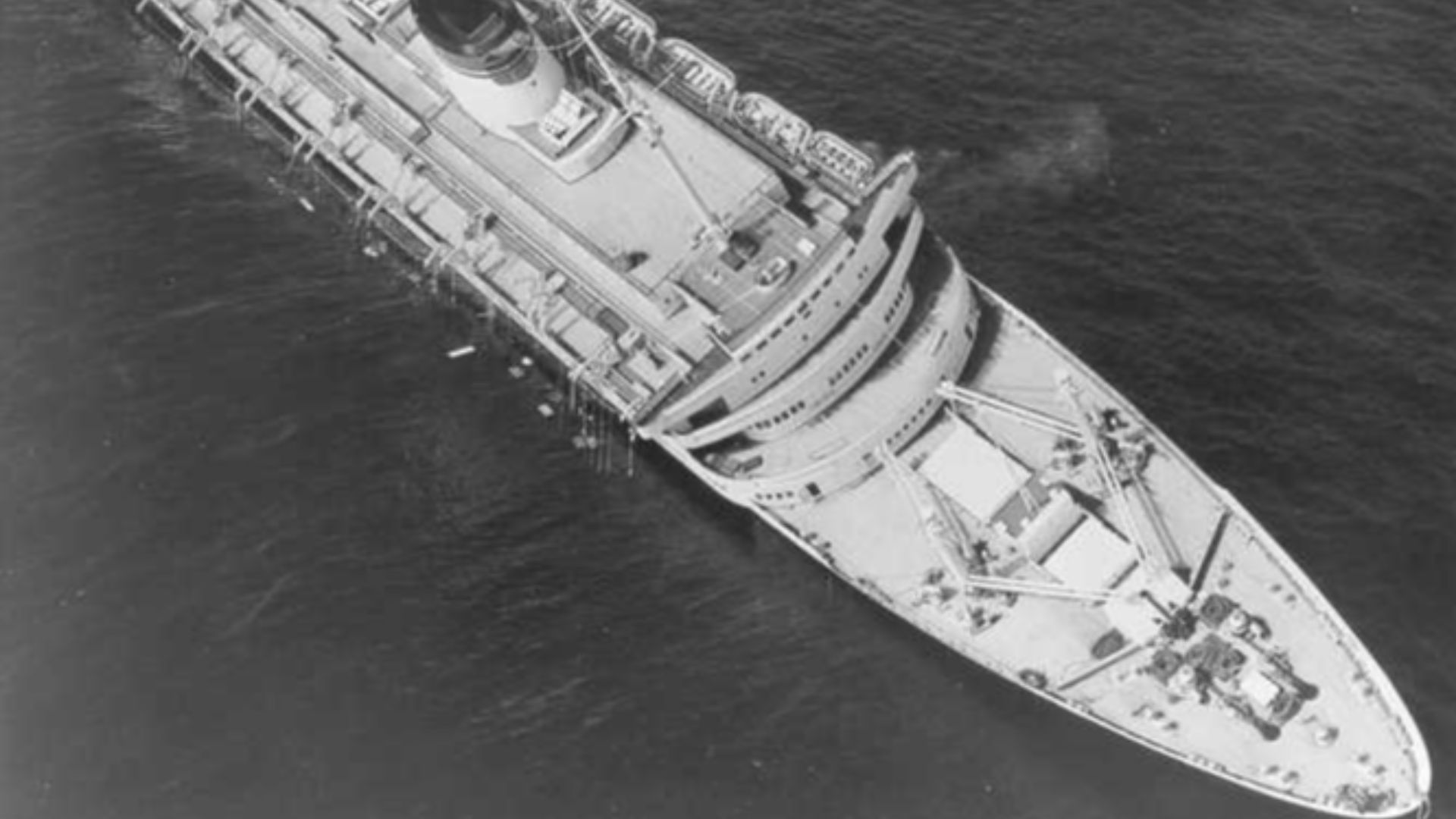 The SS Andrea Doria sinking after being struck by the MS Stockholm in 1956. Half of the ship's lifeboats are still onboard, a result of the severe list that developed after the ship was struck.