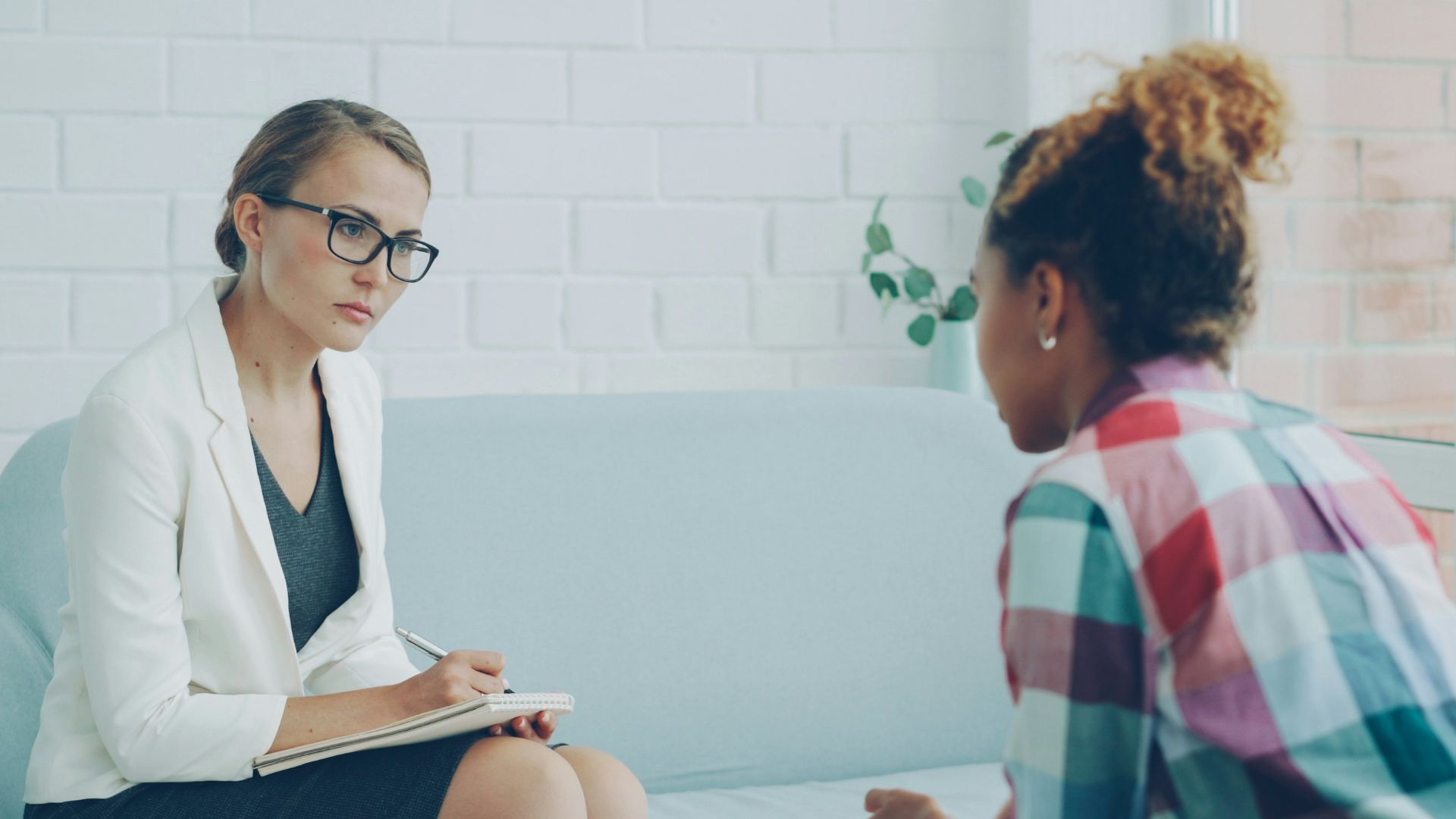 Therapist listens to patient in a counseling session.