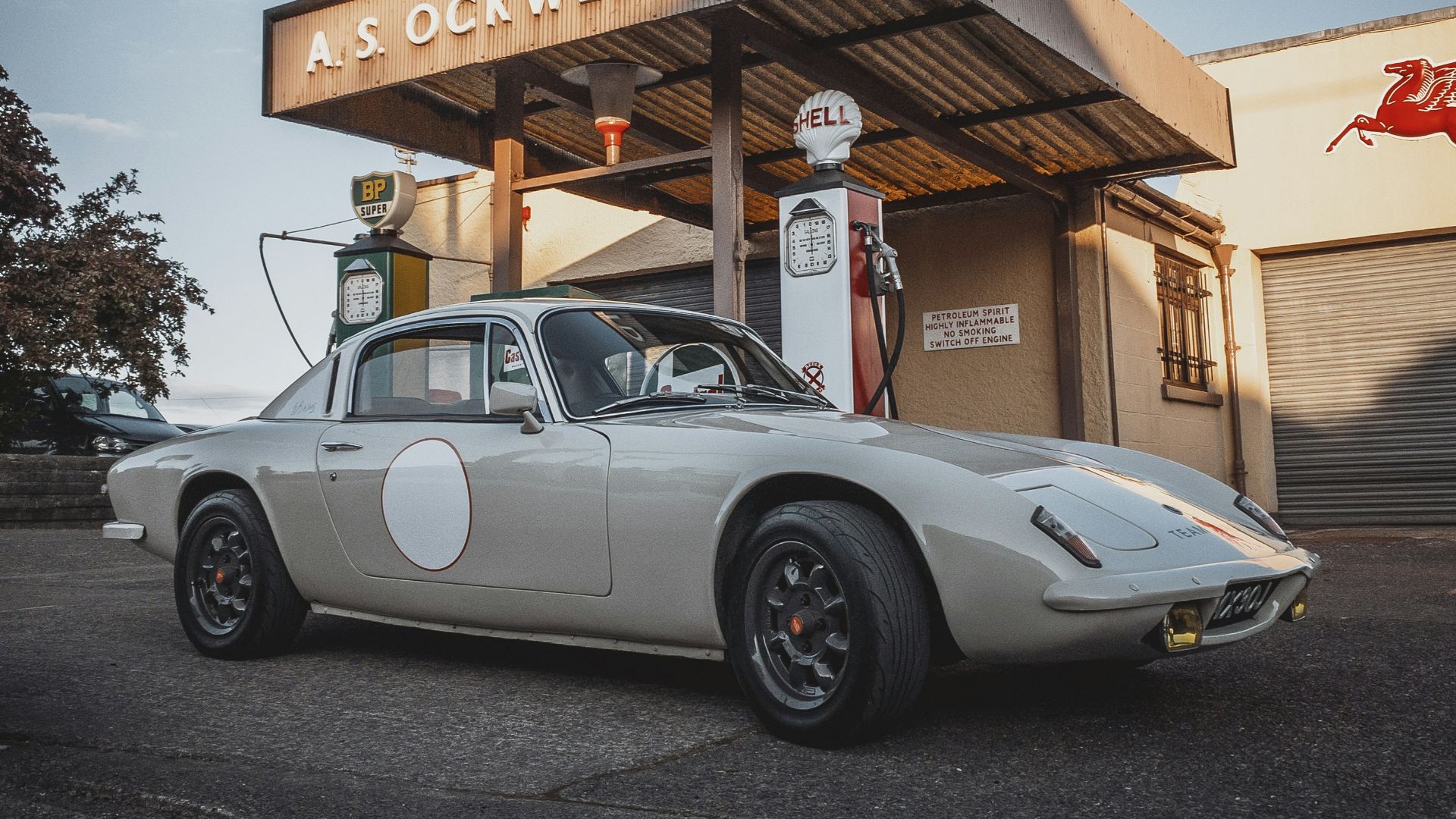 a car parked in front of a gas station