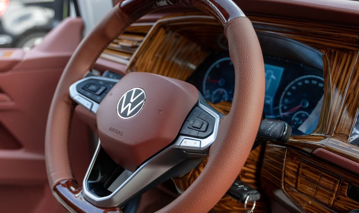 Detailed close-up of a luxury car's leather steering wheel and dashboard