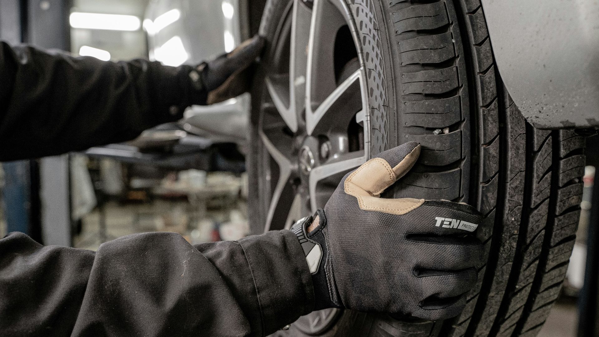 a man working on a tire in a garage