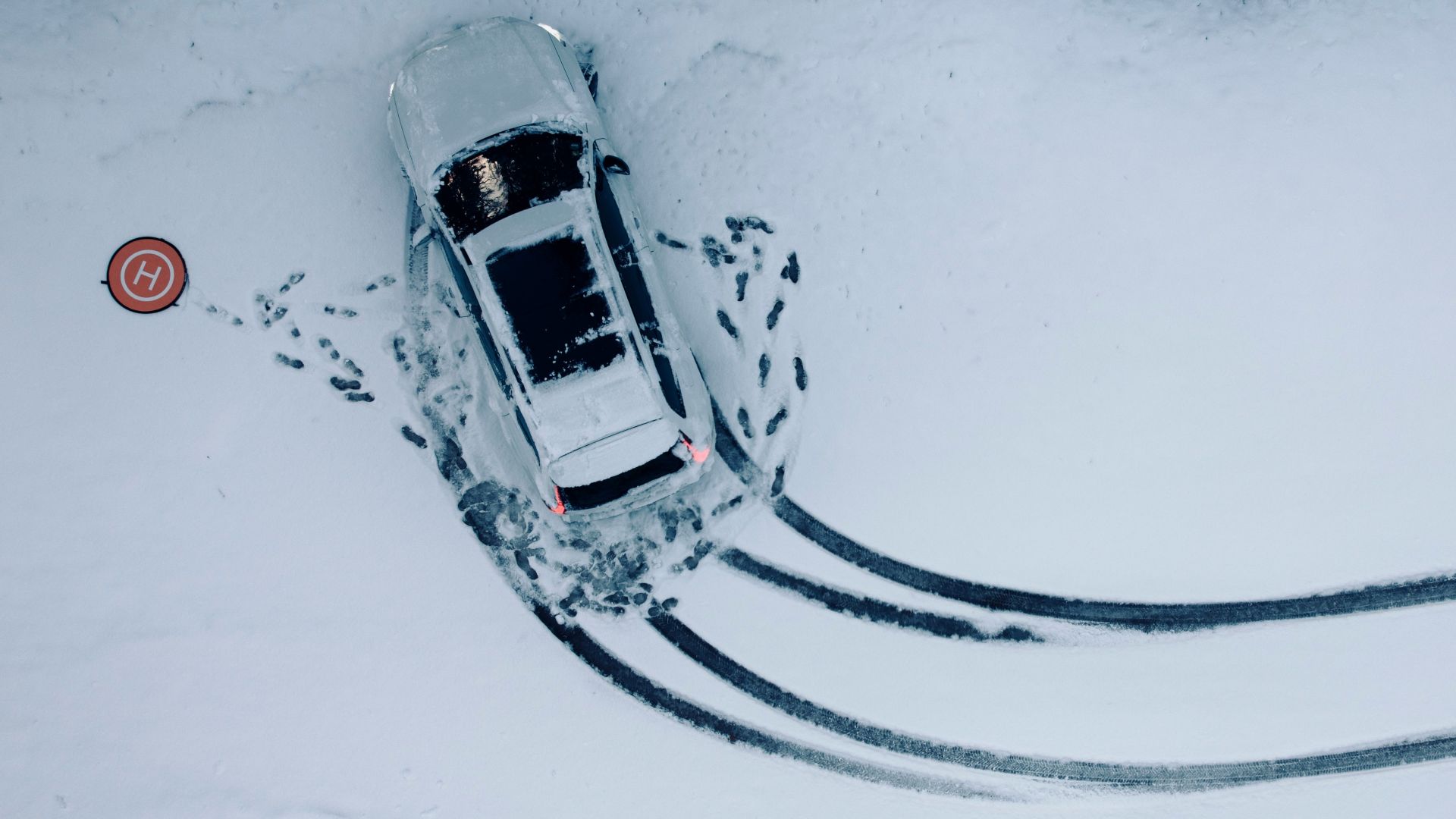 an aerial view of a car in the snow