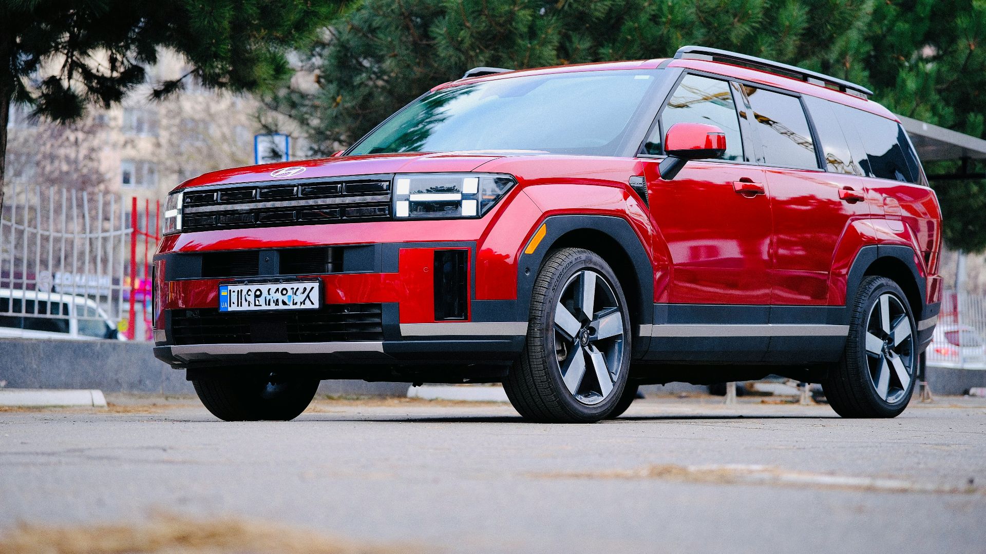 A red suv parked on a paved street