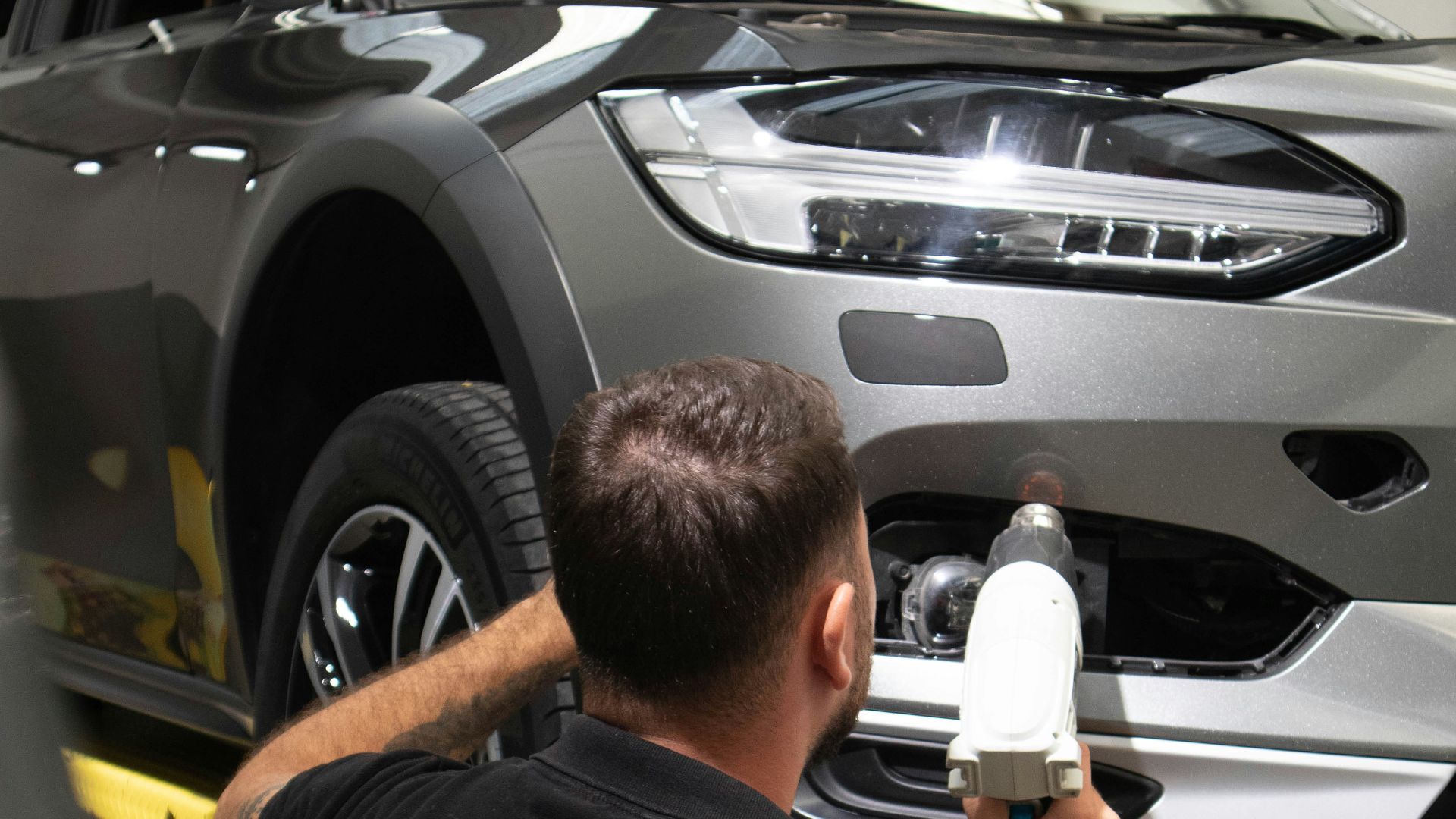 a man working on a car in a garage