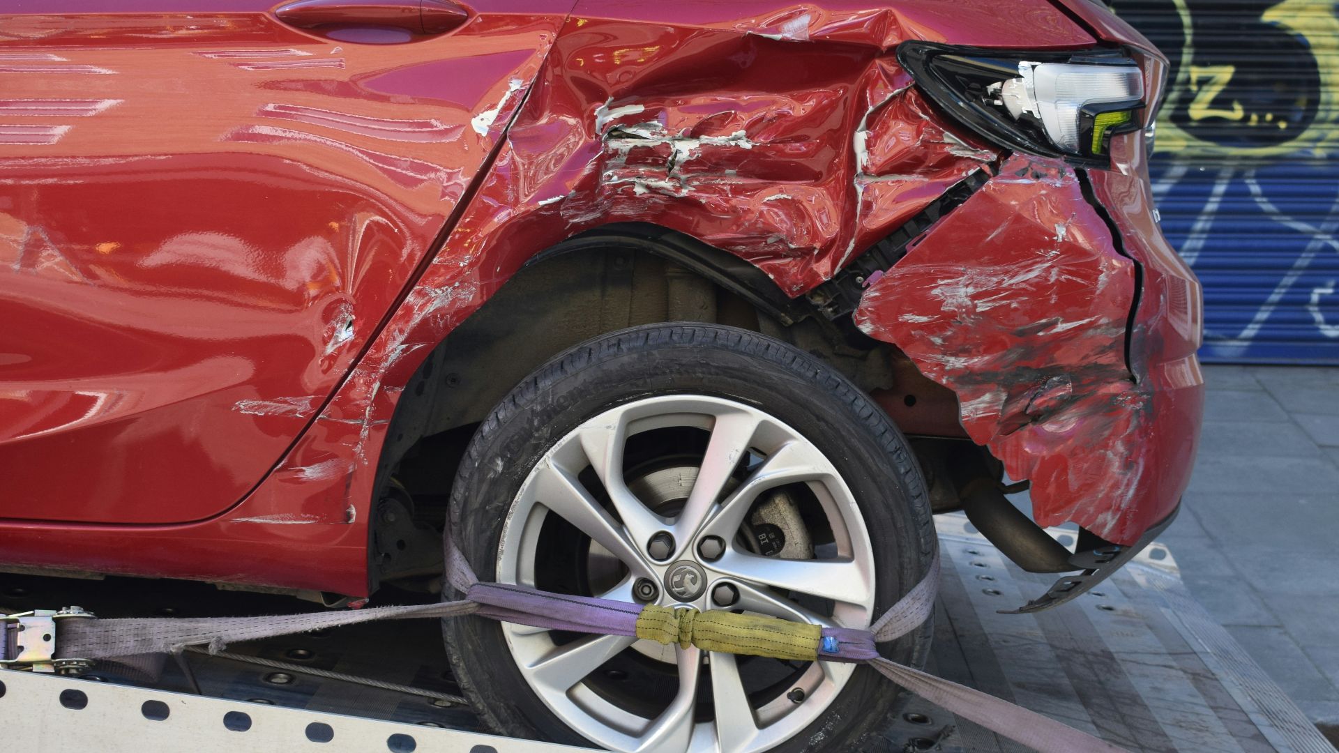 a red car is on a flatbed tow truck