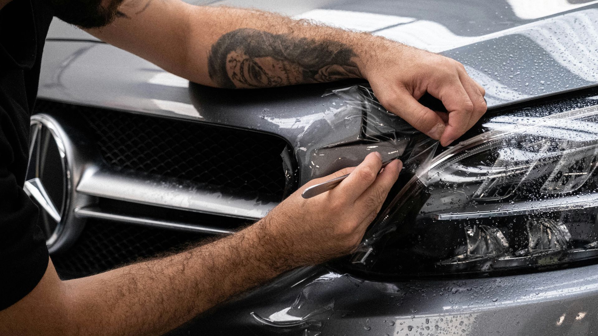 a man waxing the hood of a car