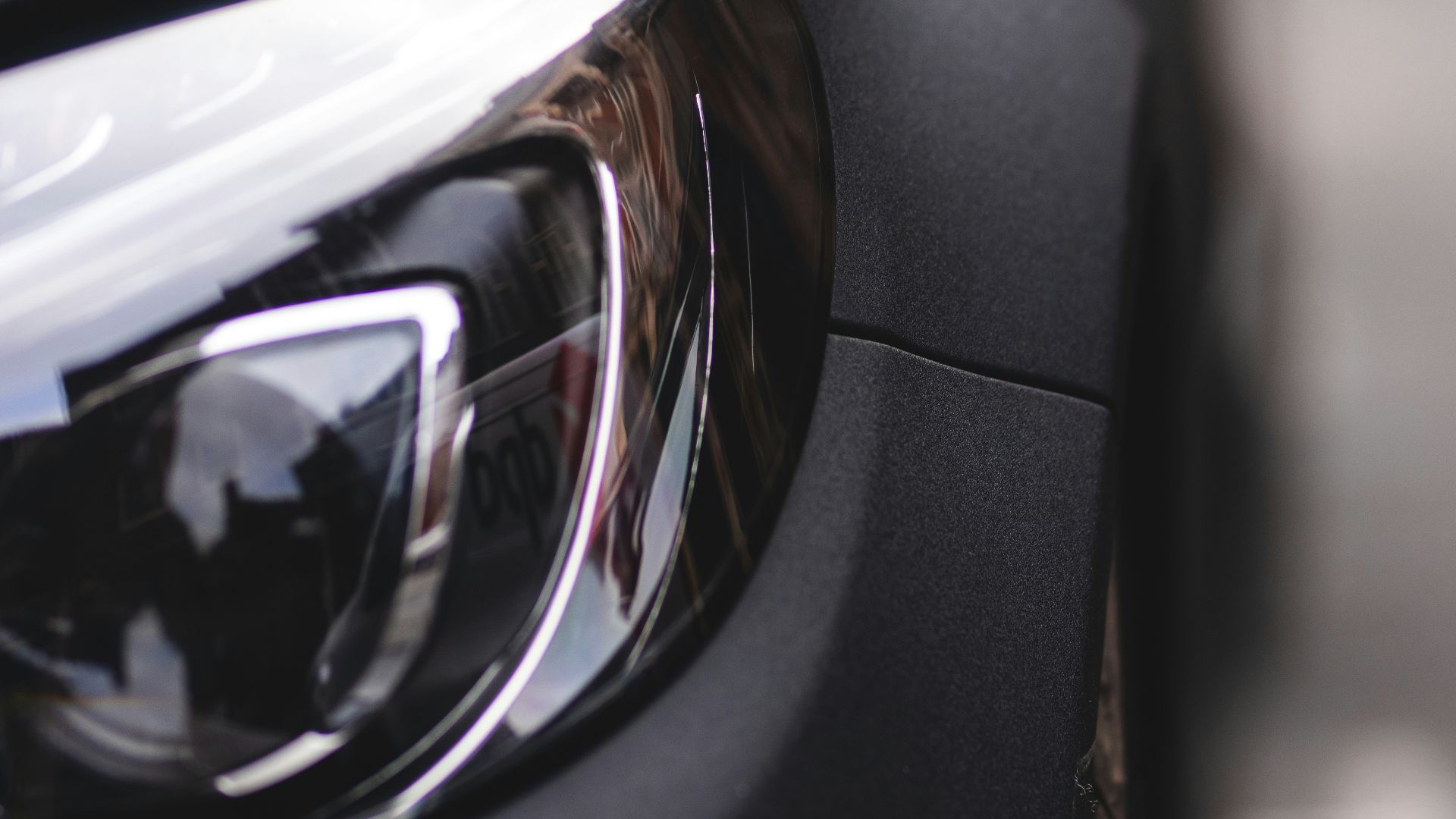 black car with black and silver headlight