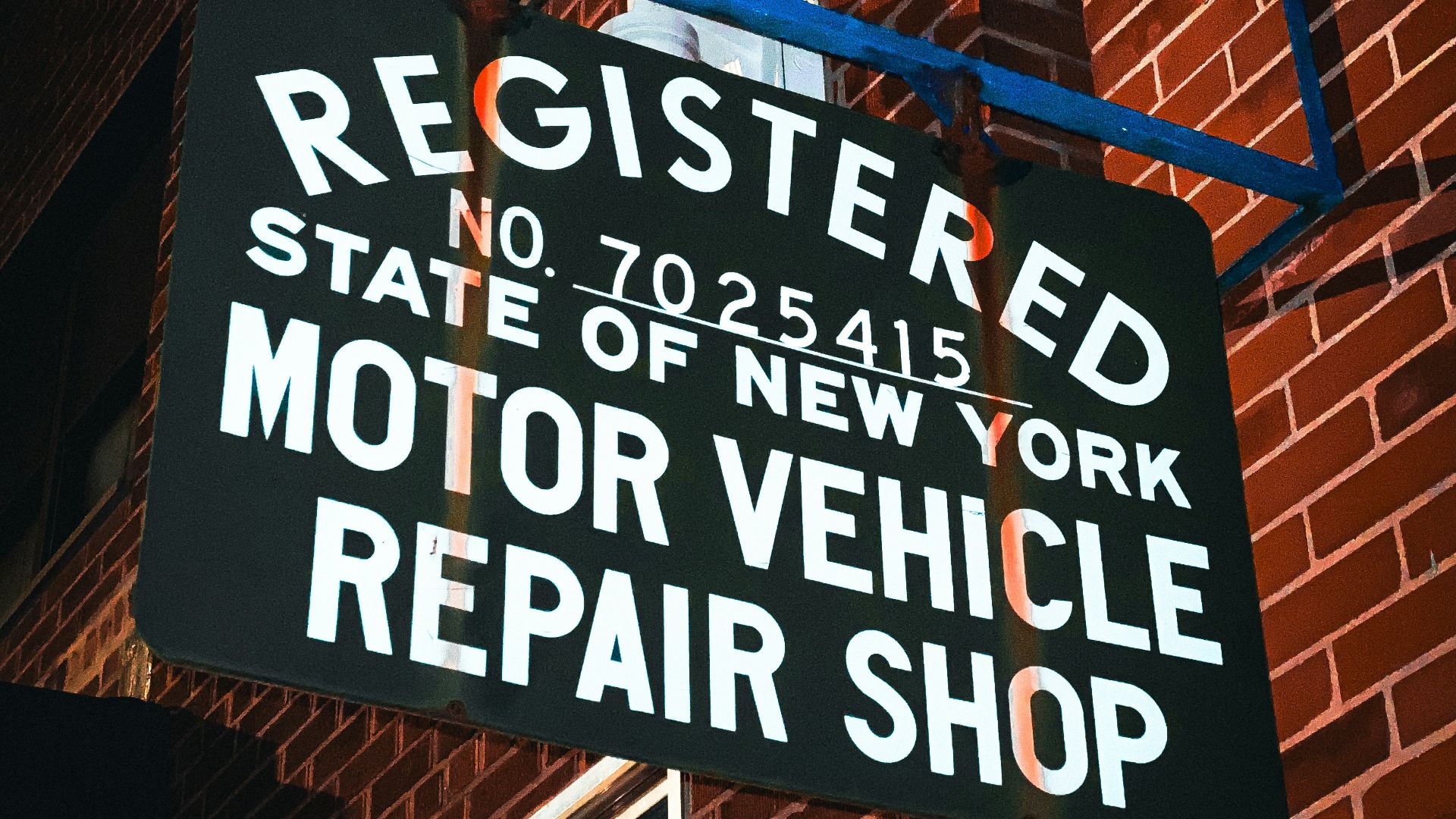 a sign on the side of a red brick building