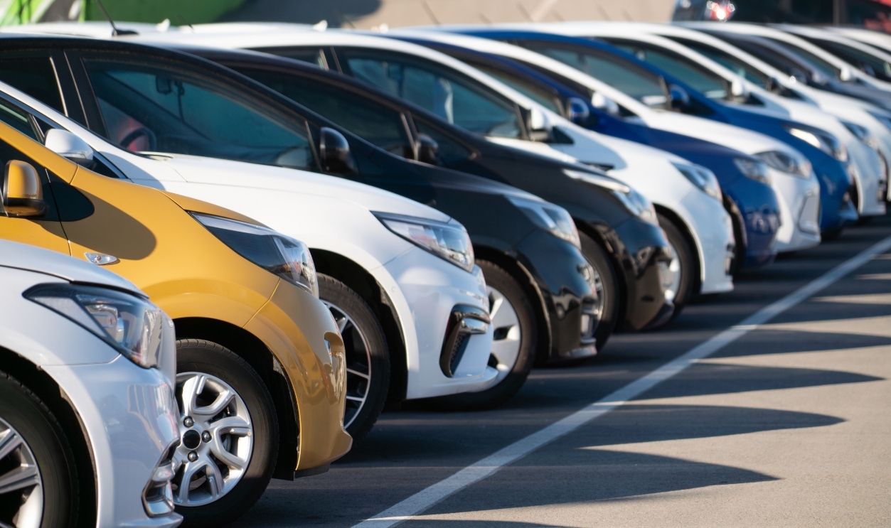 A lot of cars in a rows. Used car sales.