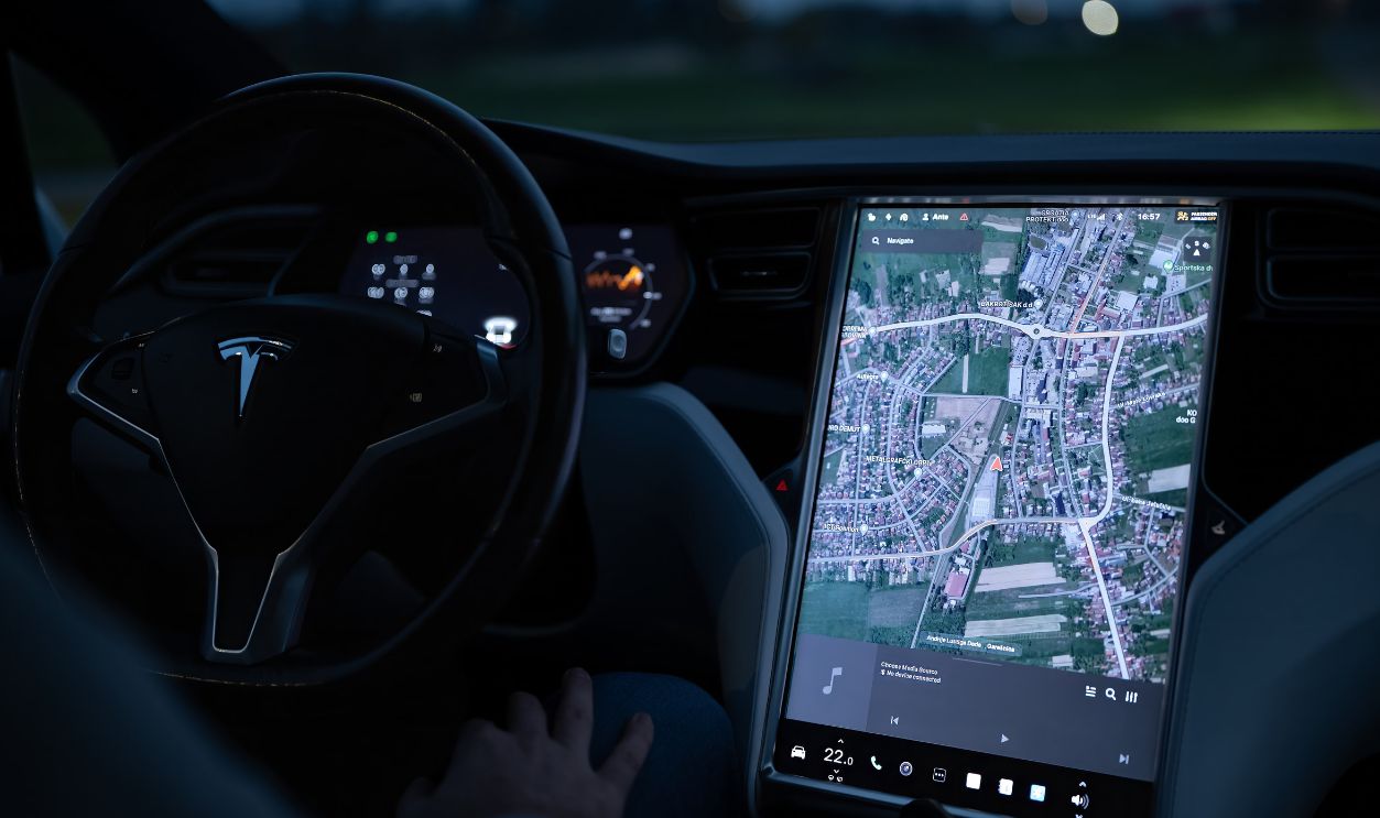 Explore the advanced touchscreen navigation in a modern electric vehicle's sleek interior at night