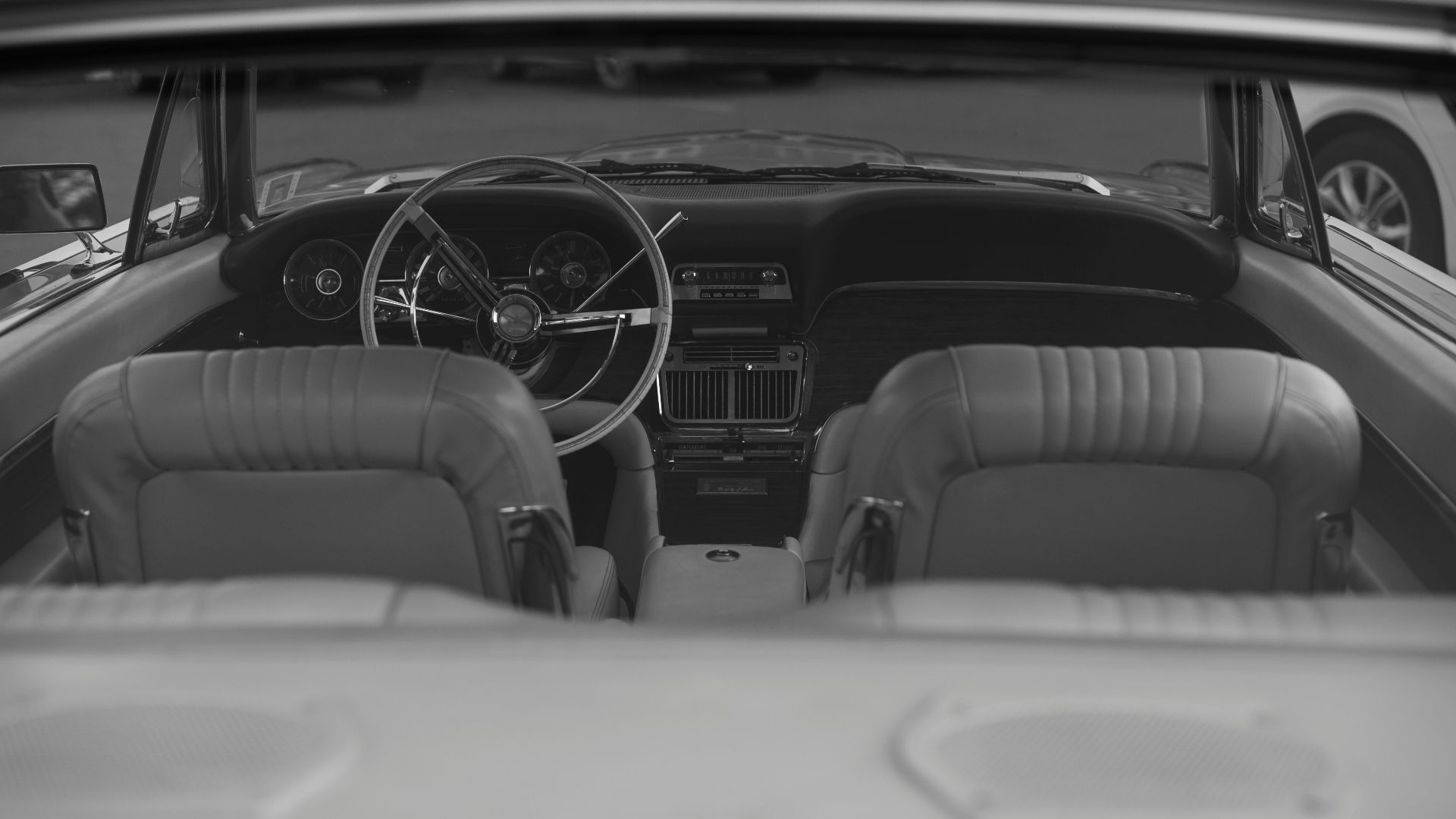 Classic car interior, viewed from the back seat.