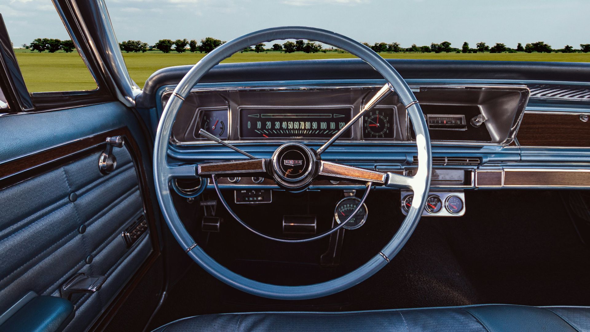 The interior of a car with a steering wheel and dashboard