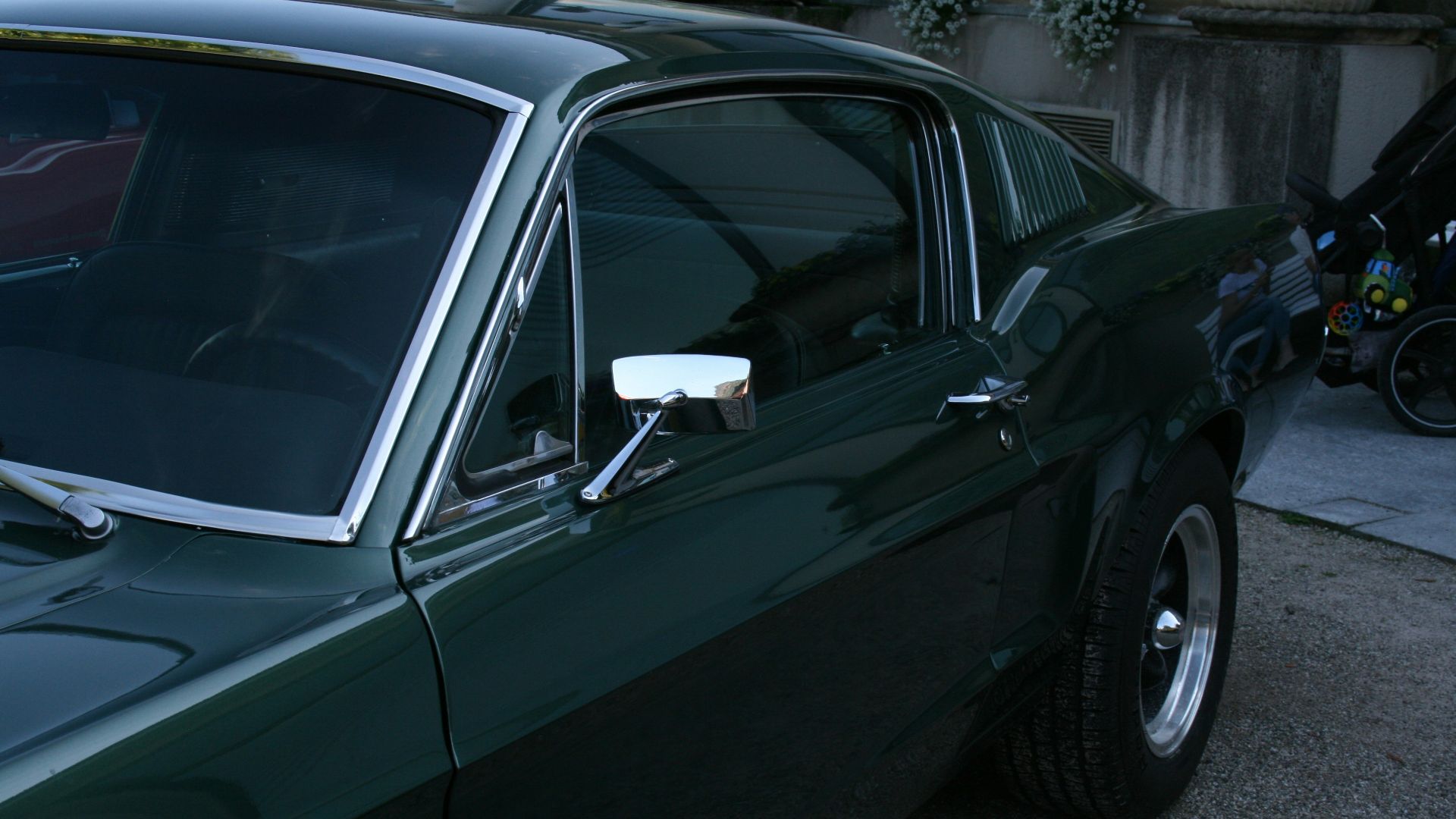 A green car parked on the side of the road