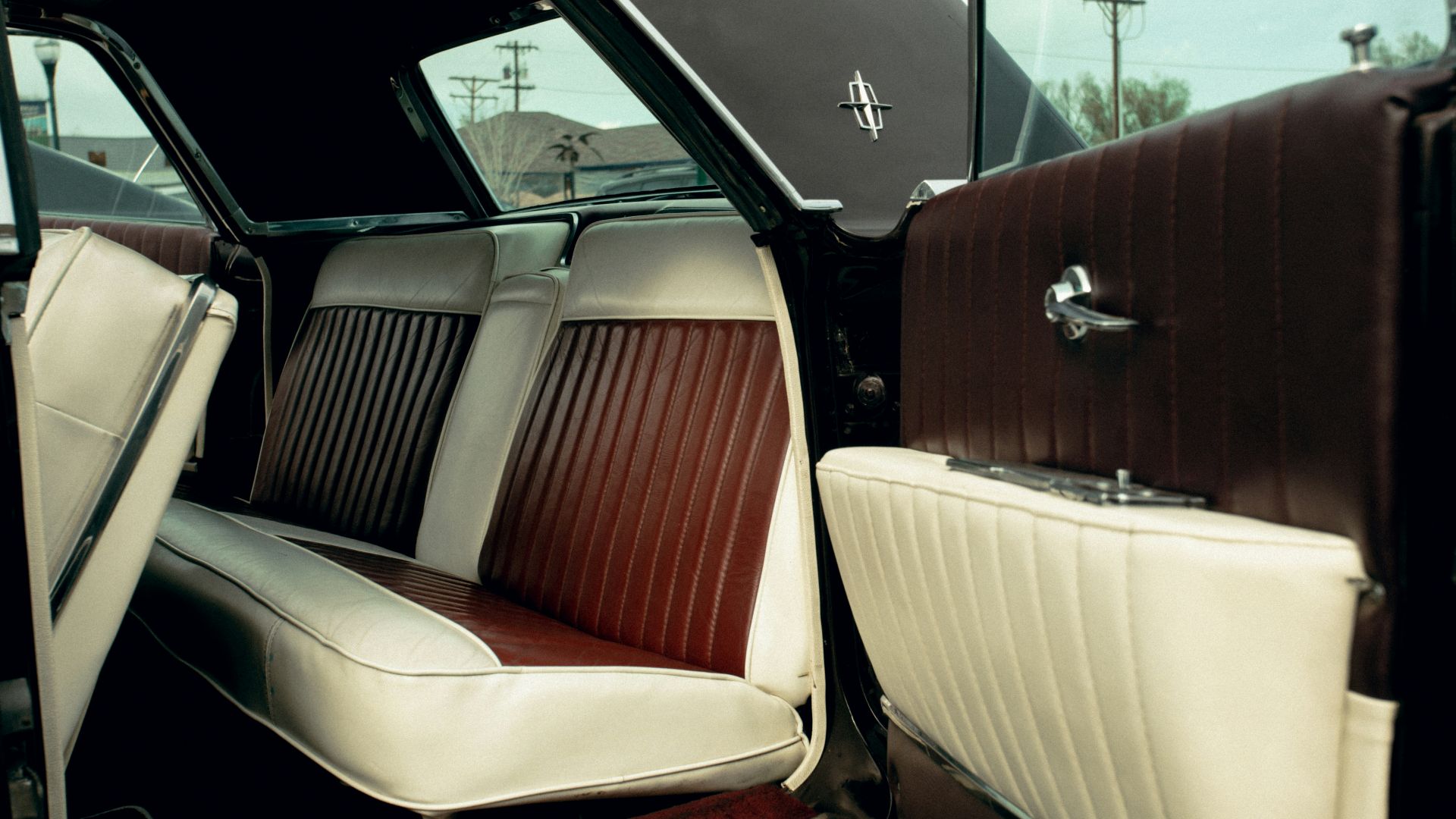 the interior of a classic car with leather seats