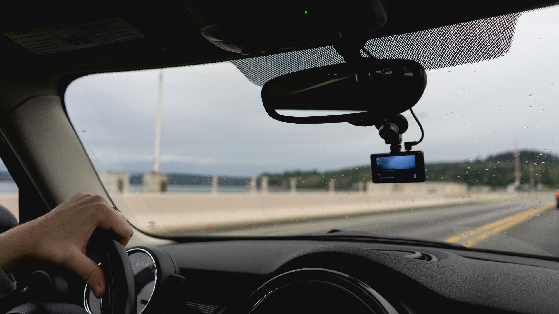 a person driving a car on a highway