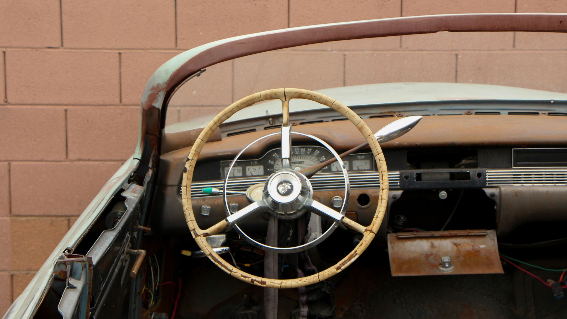 the interior of an old car with a steering wheel