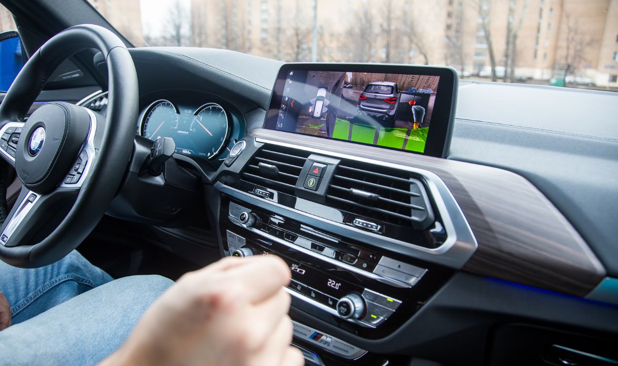 Moscow, Russia - November 7, 2019: unrecognizable man controls a 360 surround view assist system of a modern car with gestures. Close-up, background in blur. modern technology concept, road assistance