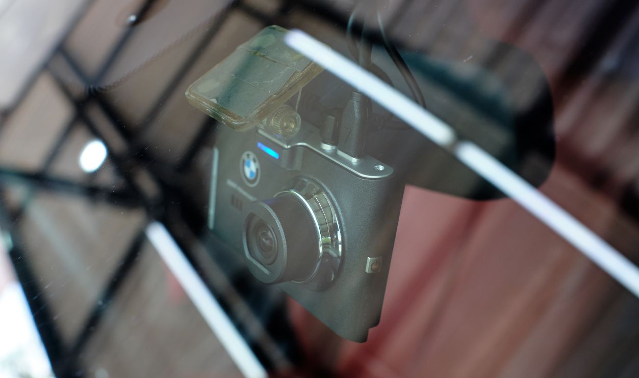 BANGKOK, THAILAND - AUGUST 12, 2020: Close up of BMW car camera mount on windshield. Car camcorder is onboard camera that records the view through a vehicle's front windscreen. Dashcams concept.