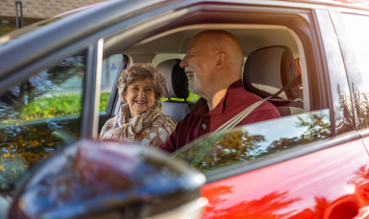 Happy Senior Couple travelling in their car