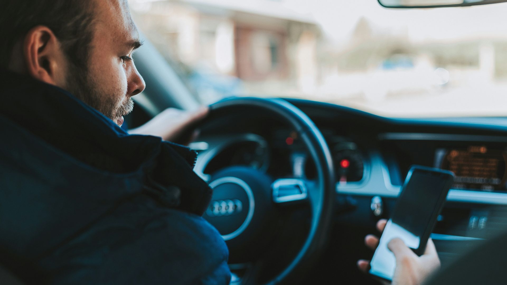 man holding black smartphone