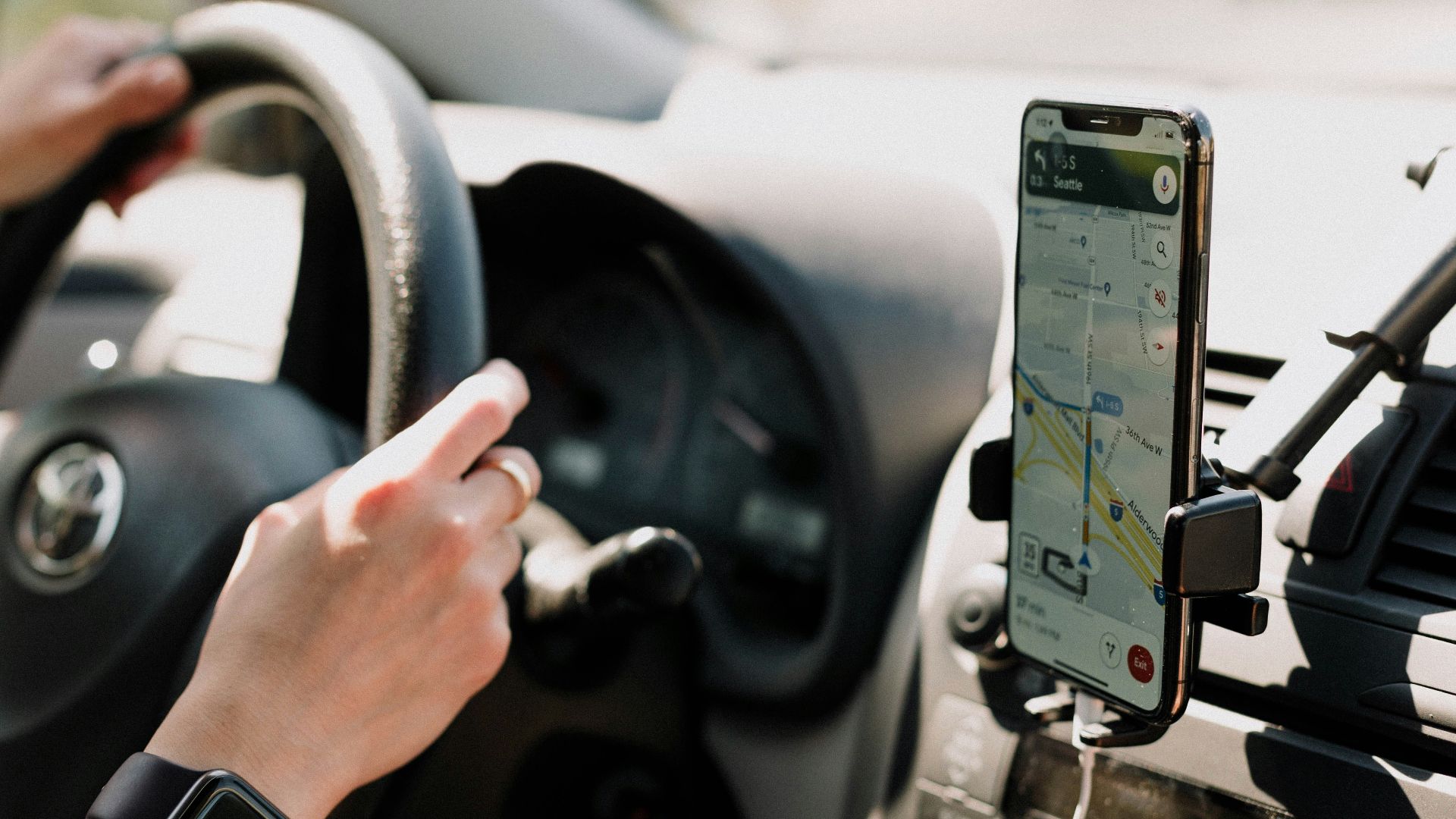a person using a cell phone while driving a car