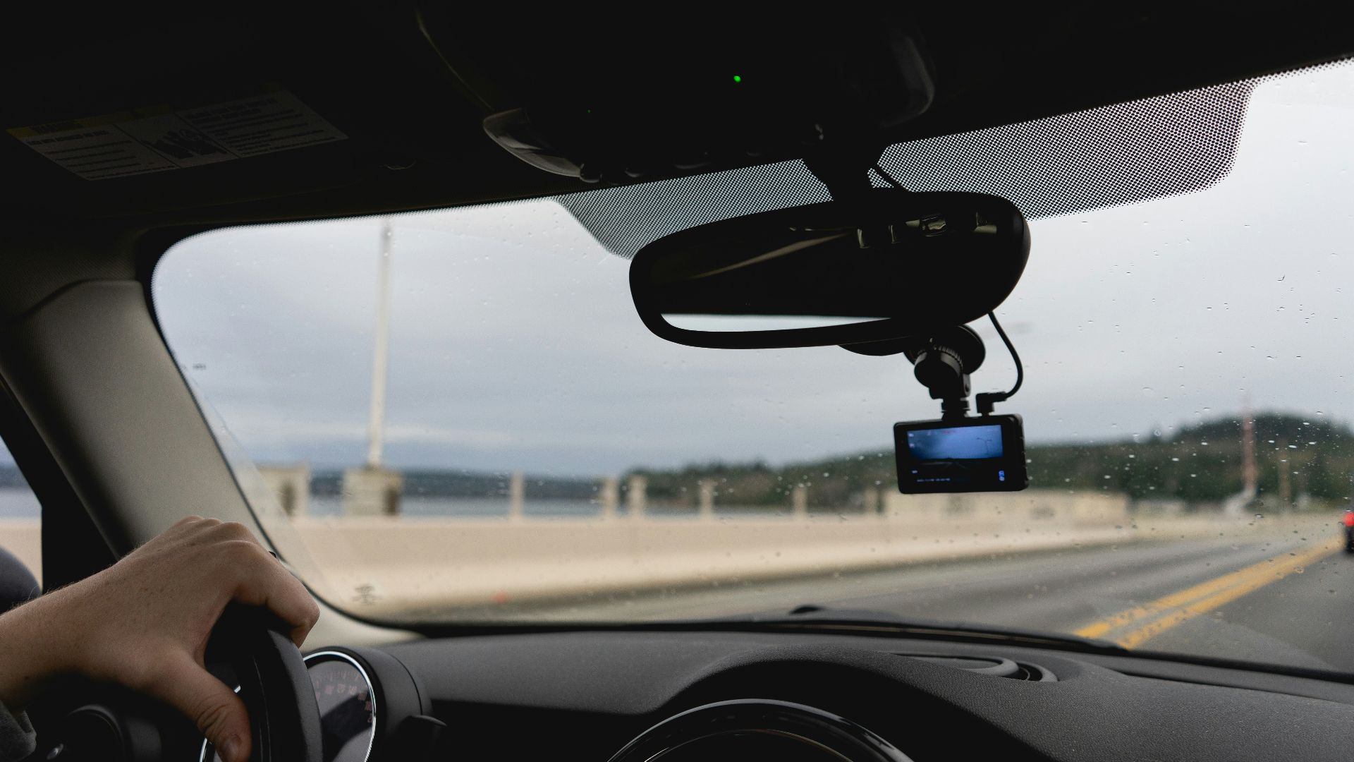 a person driving a car on a highway