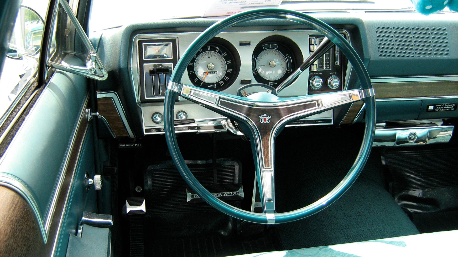 1967 Ambassador 990 four-door sedan by American Motors Corporation (AMC). Driver's cockpit and instruments. Note:the factory optional AM/FM radio (unique vertical dial) and the dealer accessory tissue dispenser (under dash on passenger's side). This car