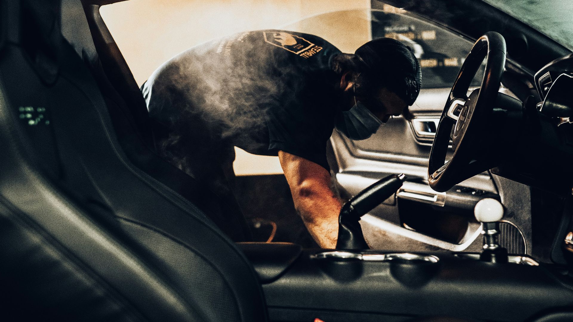 man in black t-shirt driving car