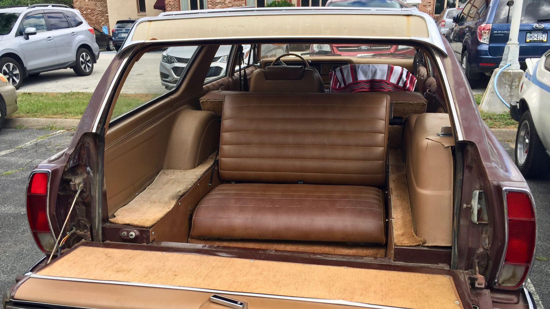 1975 AMC Matador four-door station wagon with room and comfort for eight adult passengers. A large-sized car built by American Motors Corporation (AMC). This car is finished in brown or Cocoa Metallic with a tan interior. It has three rows of seats and th